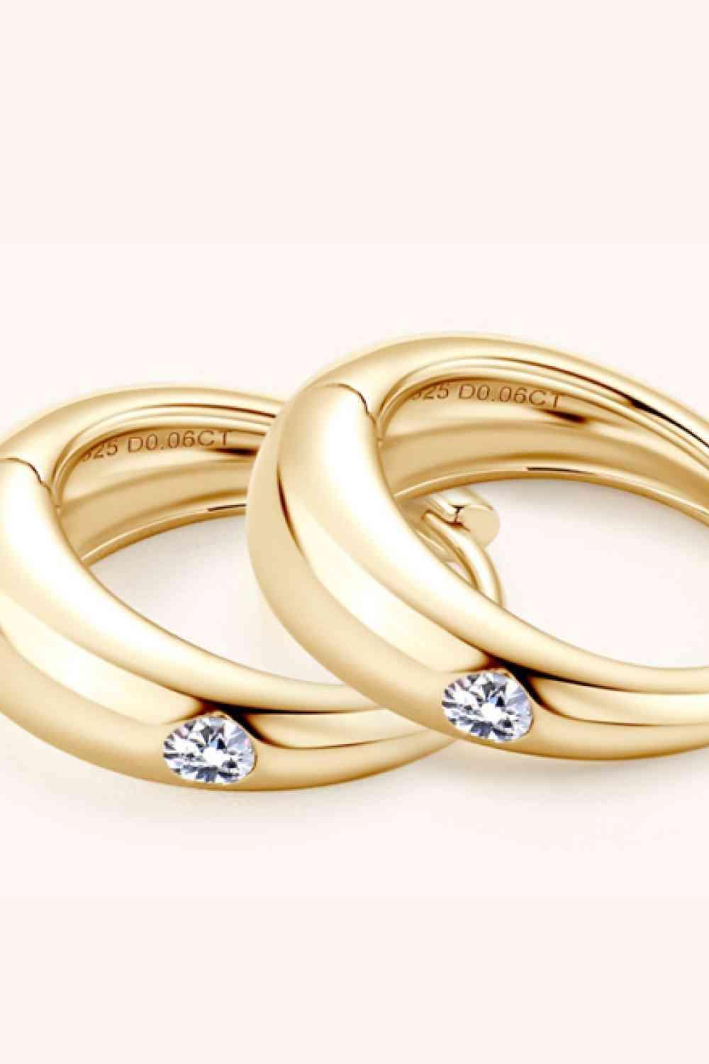 a couple of gold rings with diamonds on them