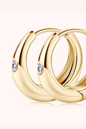 three gold rings with diamonds on a white background