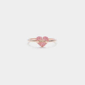 a pink heart shaped ring with two hearts on it