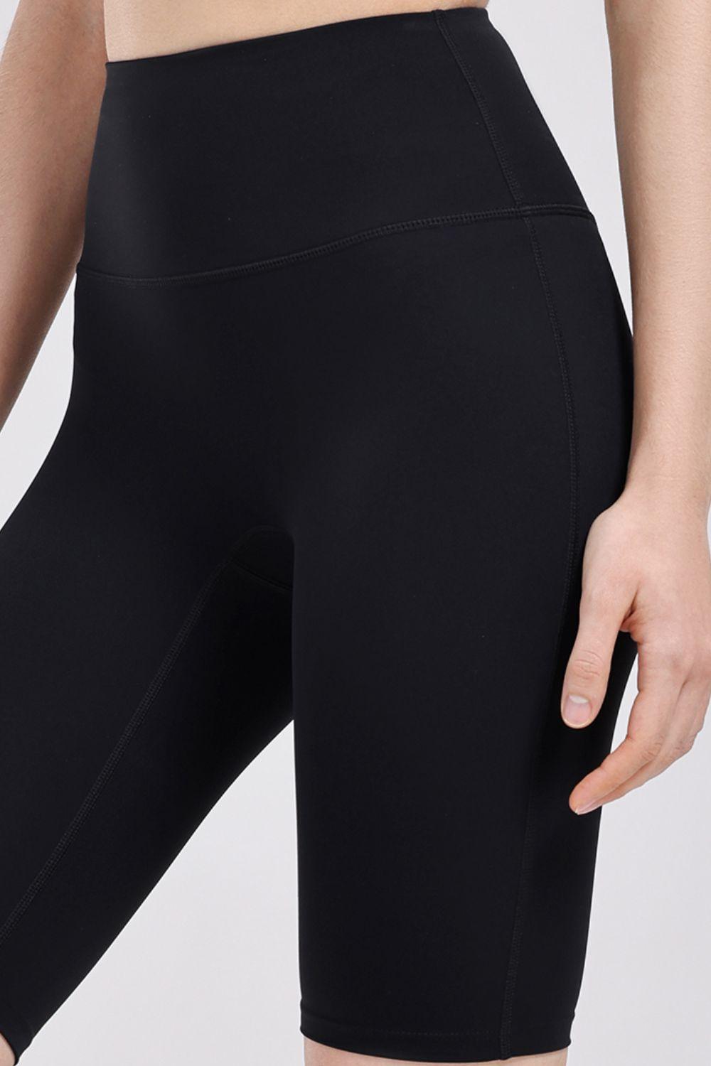 a close up of a woman's black shorts
