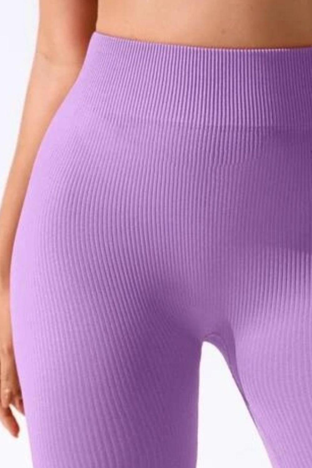 a close up of a woman's butt wearing a purple sports bra