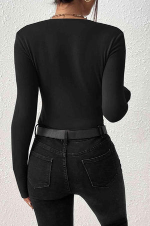 a woman wearing black jeans and a black top