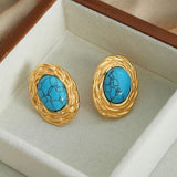 a pair of turquoise stone earrings in a box