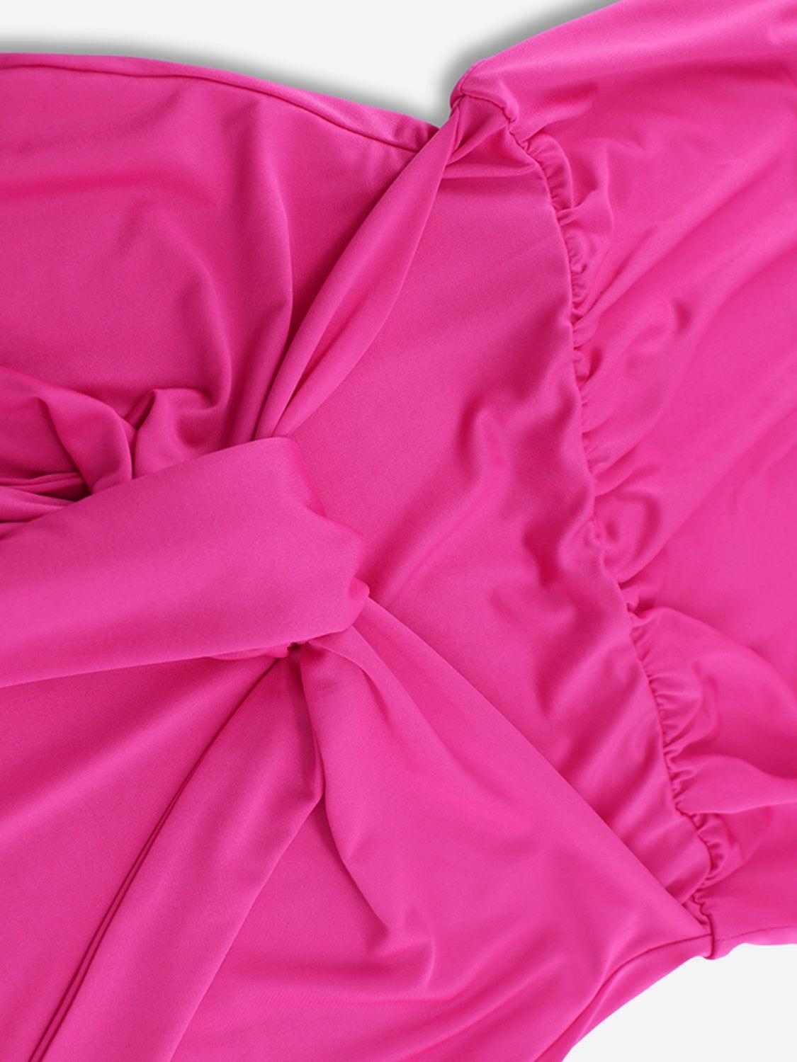 a close up of a pink dress on a white surface