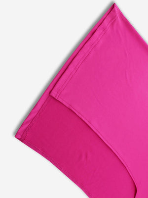 a close up of a pink pillow on a white background