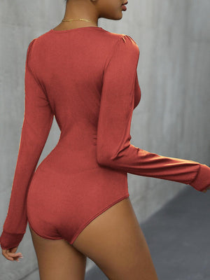 a woman in a red bodysuit posing for the camera