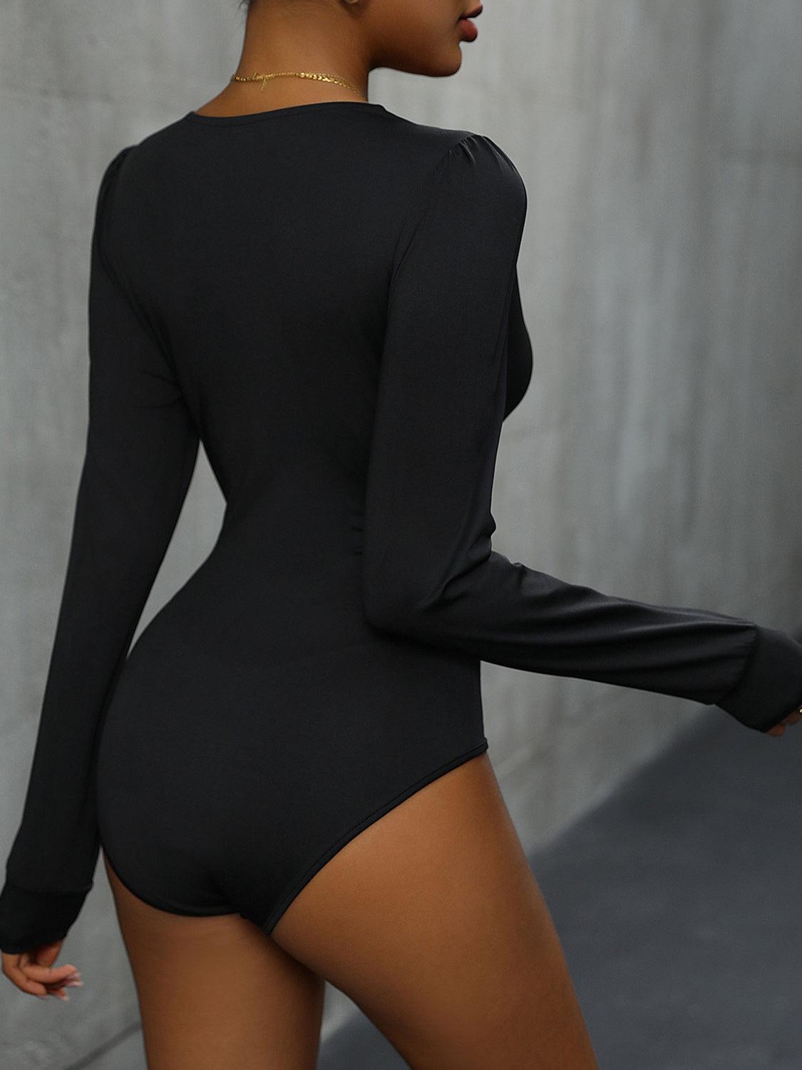 a woman in a black bodysuit is posing for the camera
