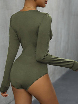 a woman in a bodysuit is posing for the camera