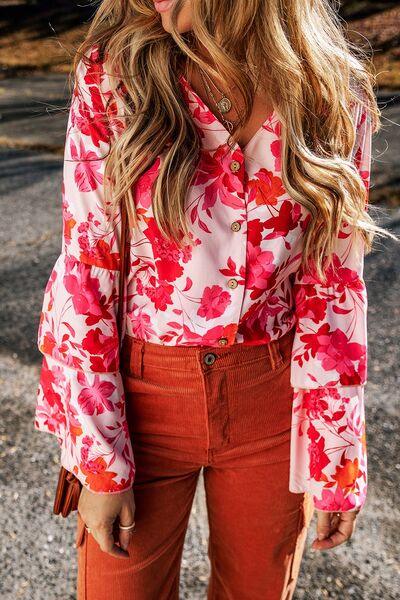 a woman with long hair wearing an orange pants and a floral shirt