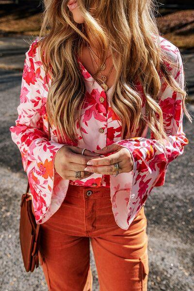 a woman with long hair wearing an orange pants and a floral shirt