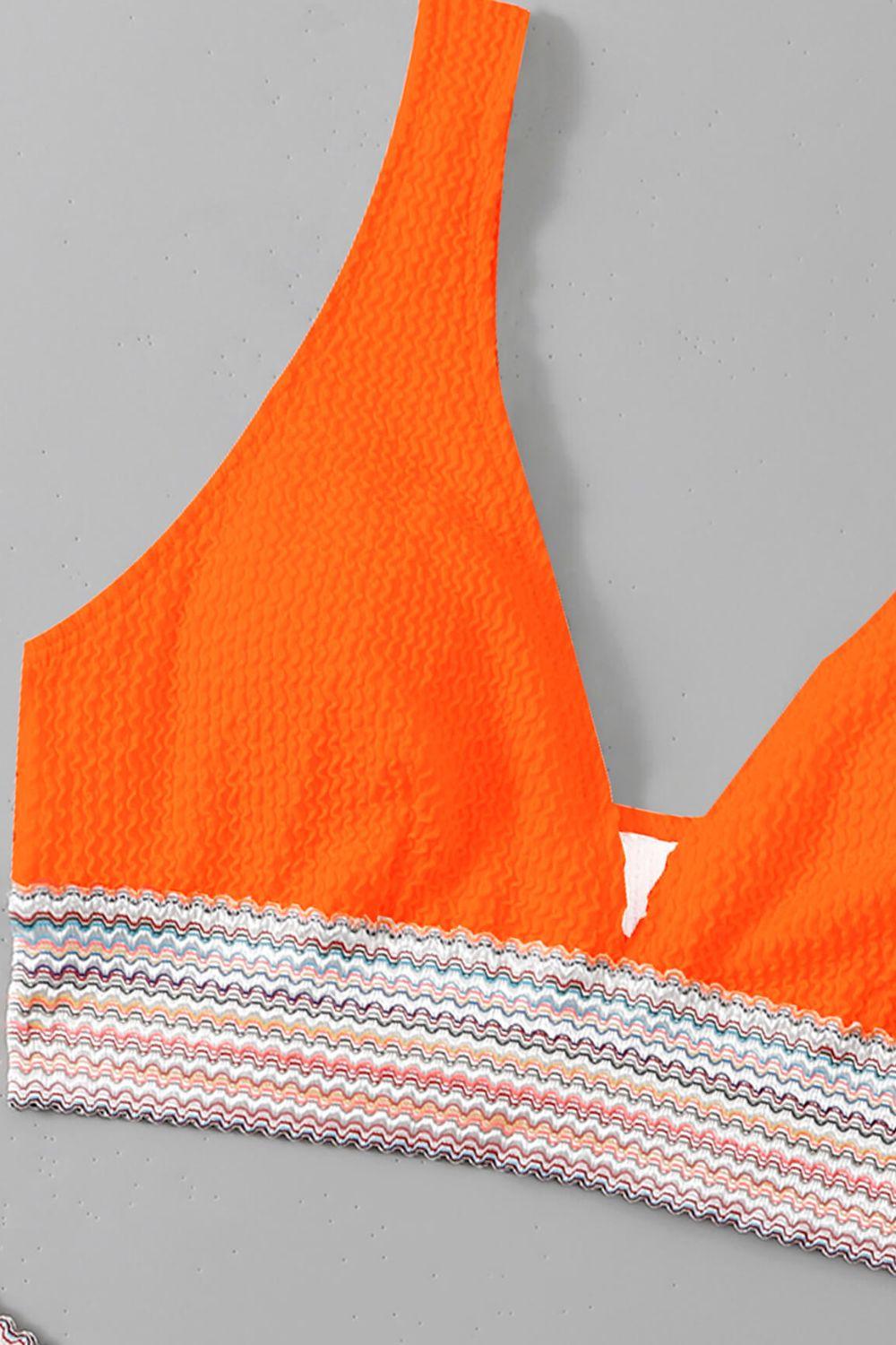 an orange bikini top with a white triangle on it