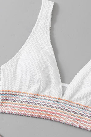 a white bra top with multicolored stripes