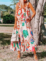 a woman standing in front of a tree wearing a dress