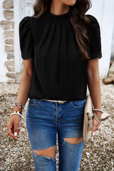 a woman wearing ripped jeans and a black top