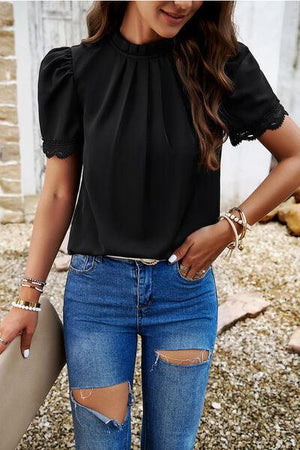 a woman wearing ripped jeans and a black top