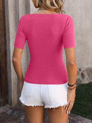 a woman wearing a pink top and white shorts