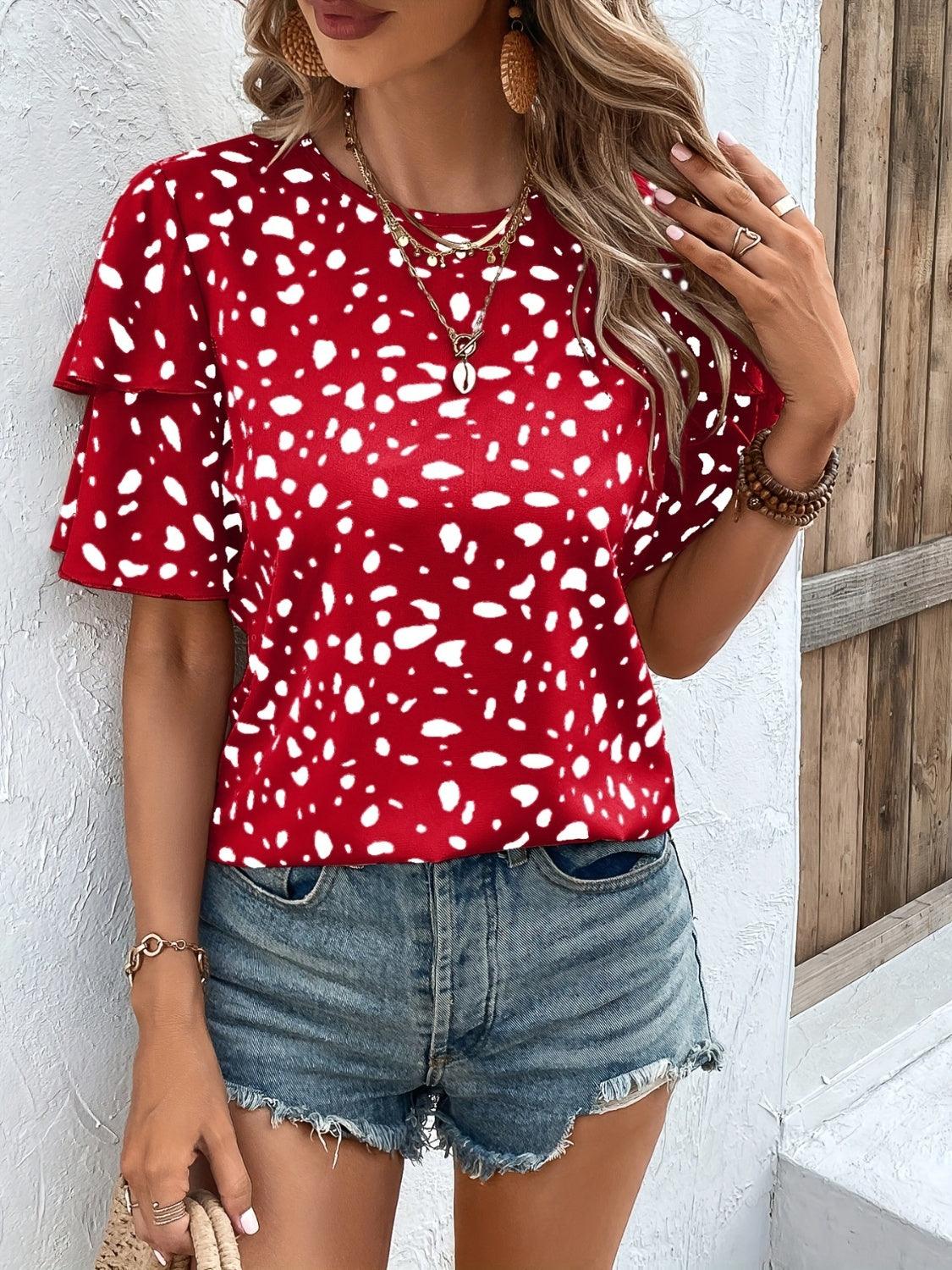 a woman wearing a red top with white spots