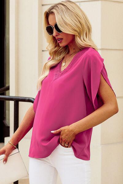 a woman in white pants and a pink top