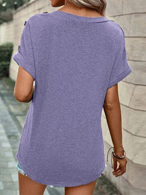 a woman wearing a purple shirt and shorts