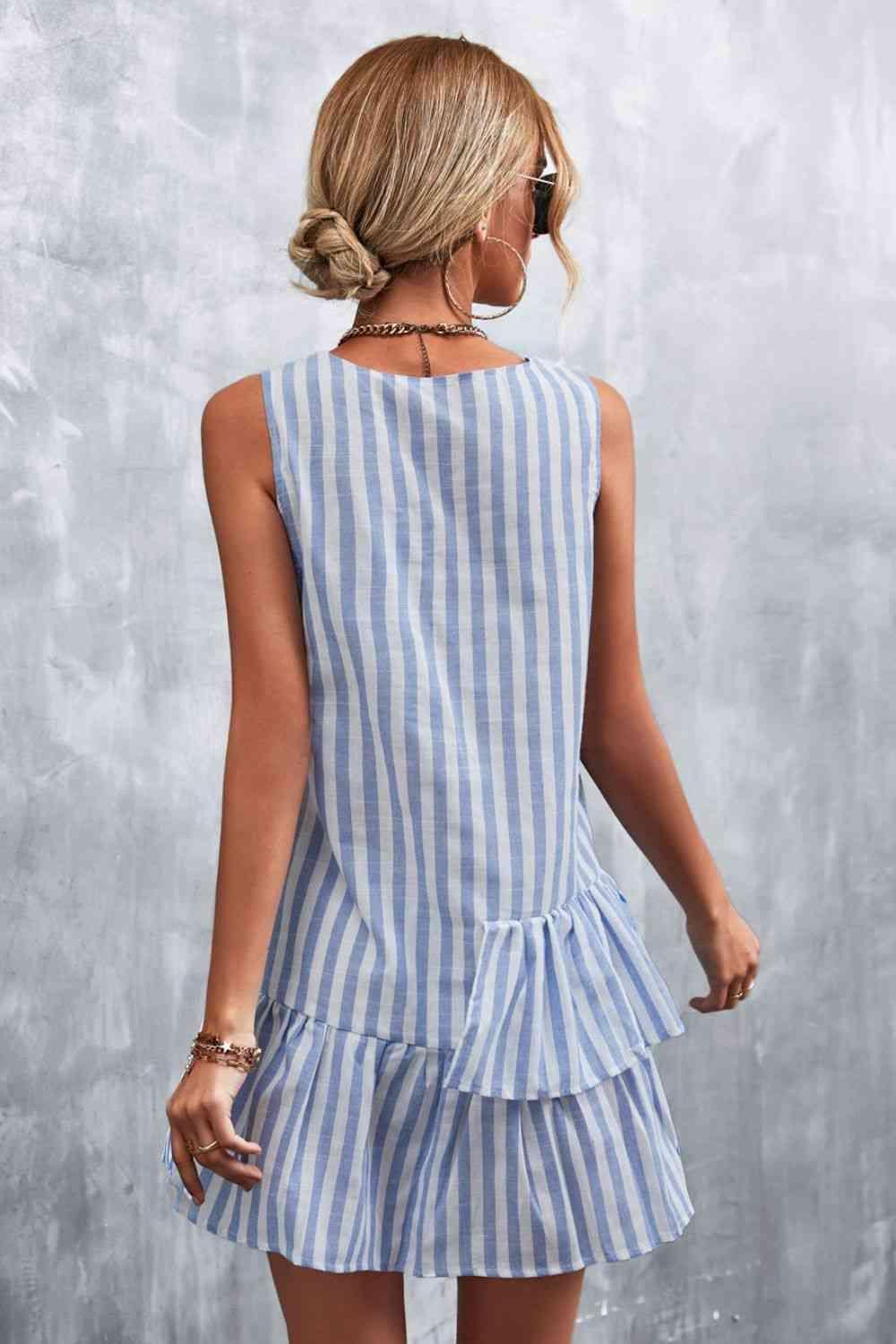 a woman wearing a blue and white striped dress