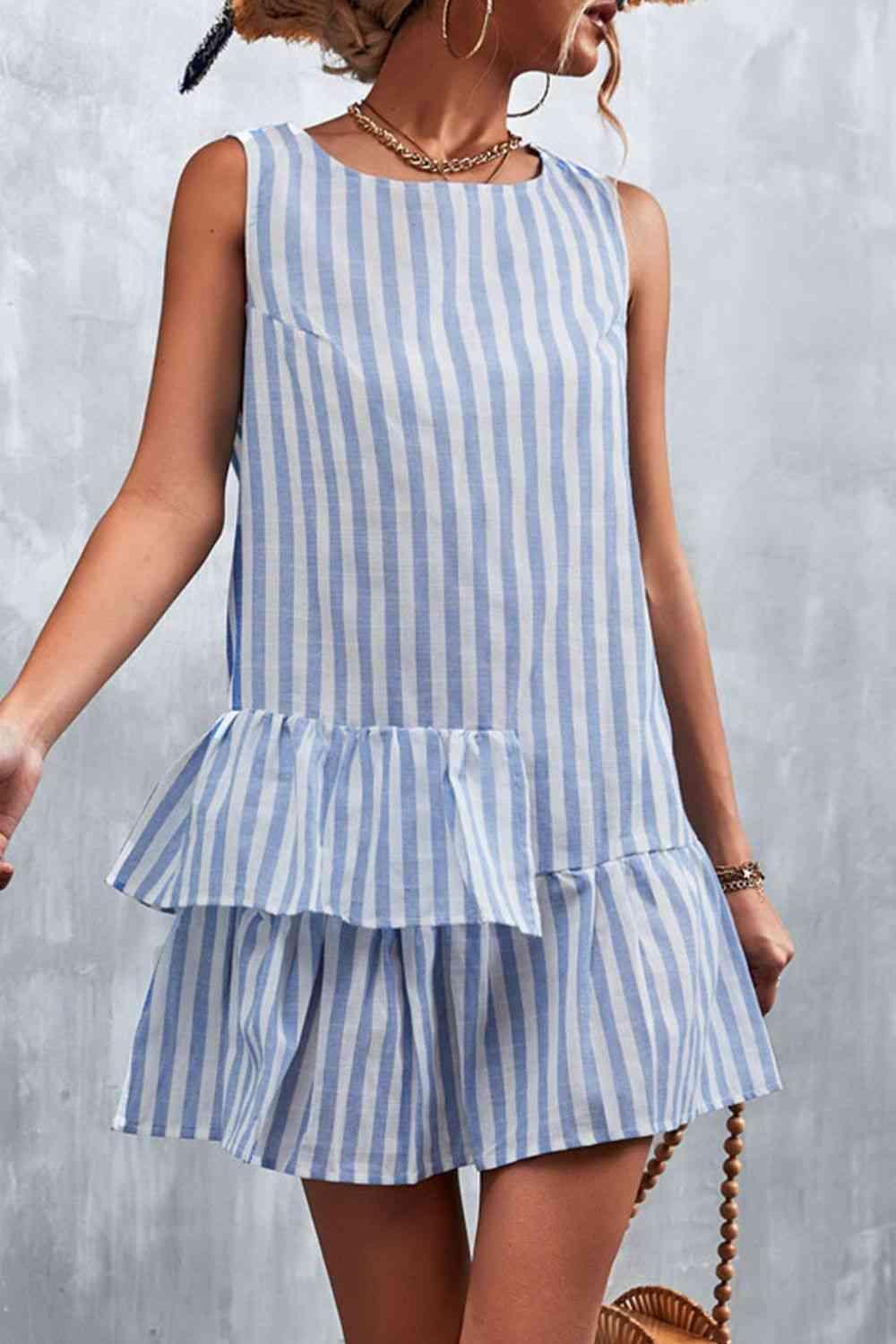 a woman wearing a blue and white striped dress