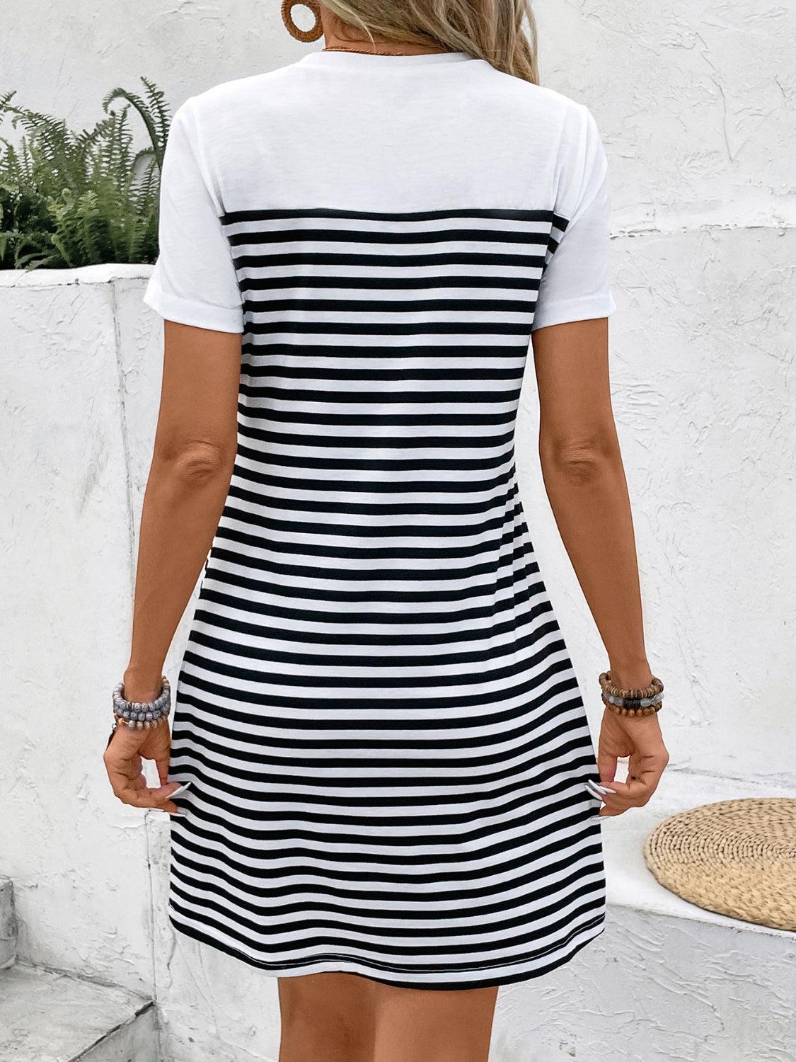 a woman wearing a black and white striped dress