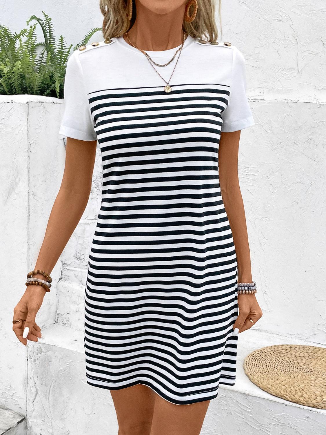 a woman wearing a black and white striped dress