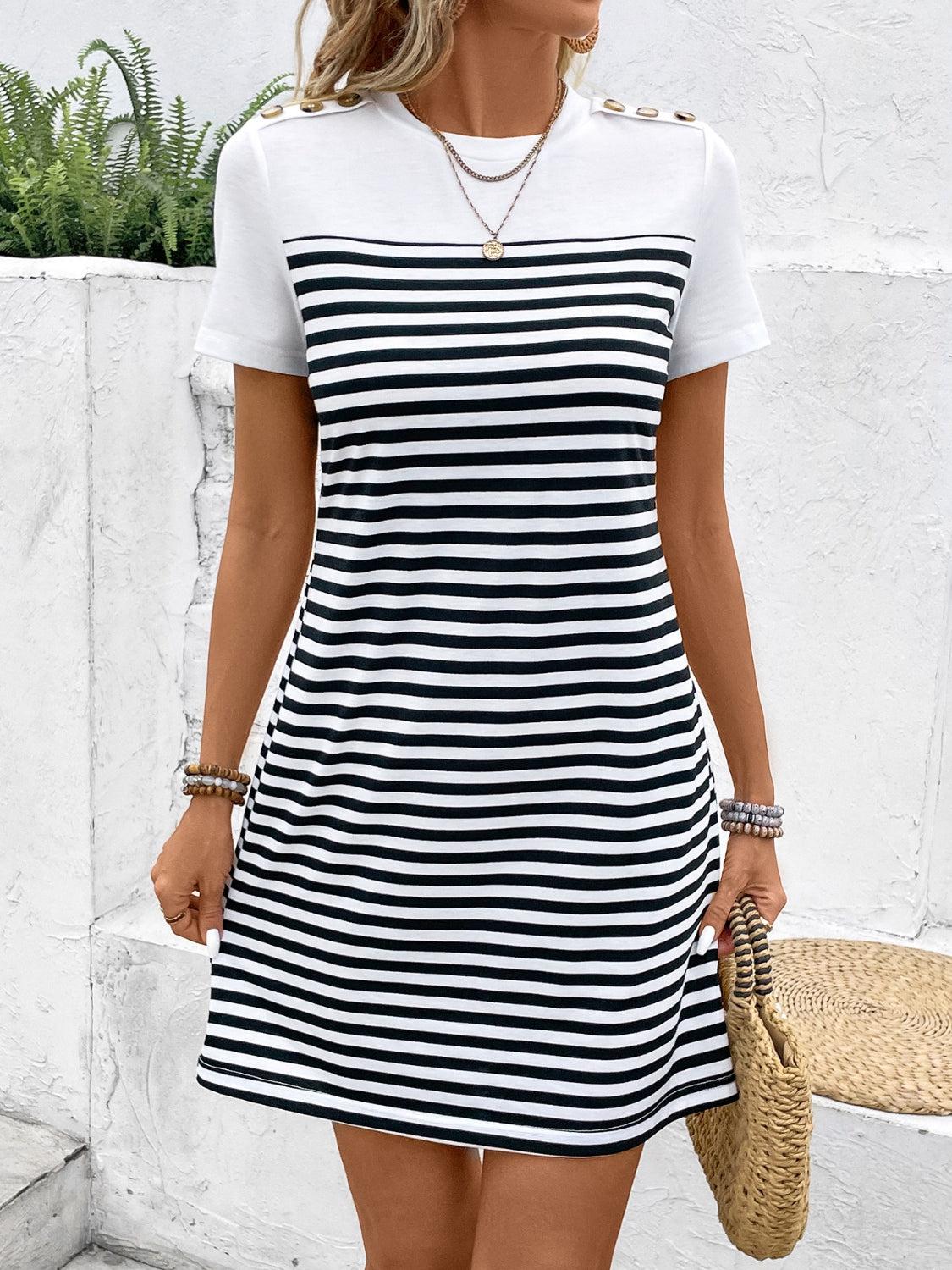 a woman wearing a black and white striped dress