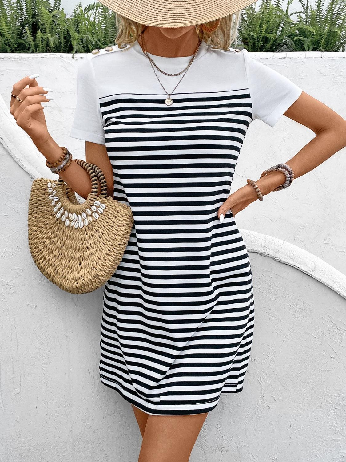 a woman wearing a hat and a striped dress