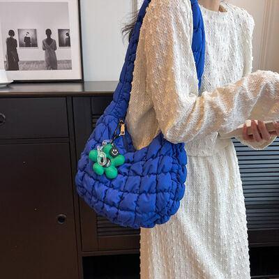 a woman in a white dress holding a blue purse