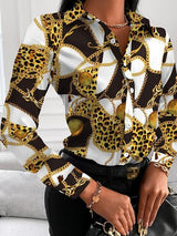 a woman wearing a leopard print shirt and black pants