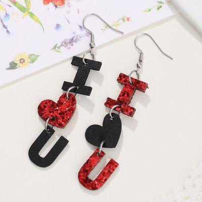 a pair of red and black earrings on a white surface