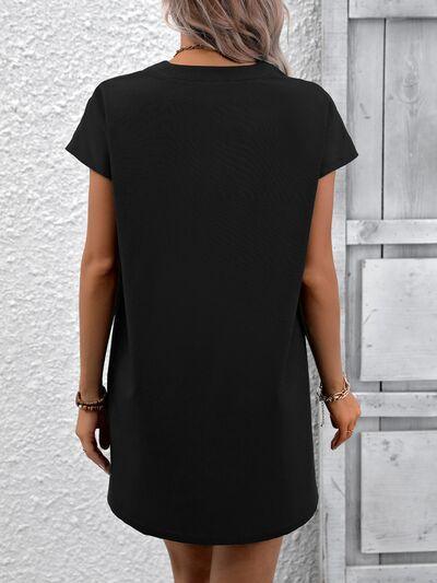 a woman wearing a black shirt dress