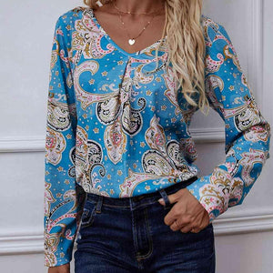 a woman wearing a blue blouse and jeans