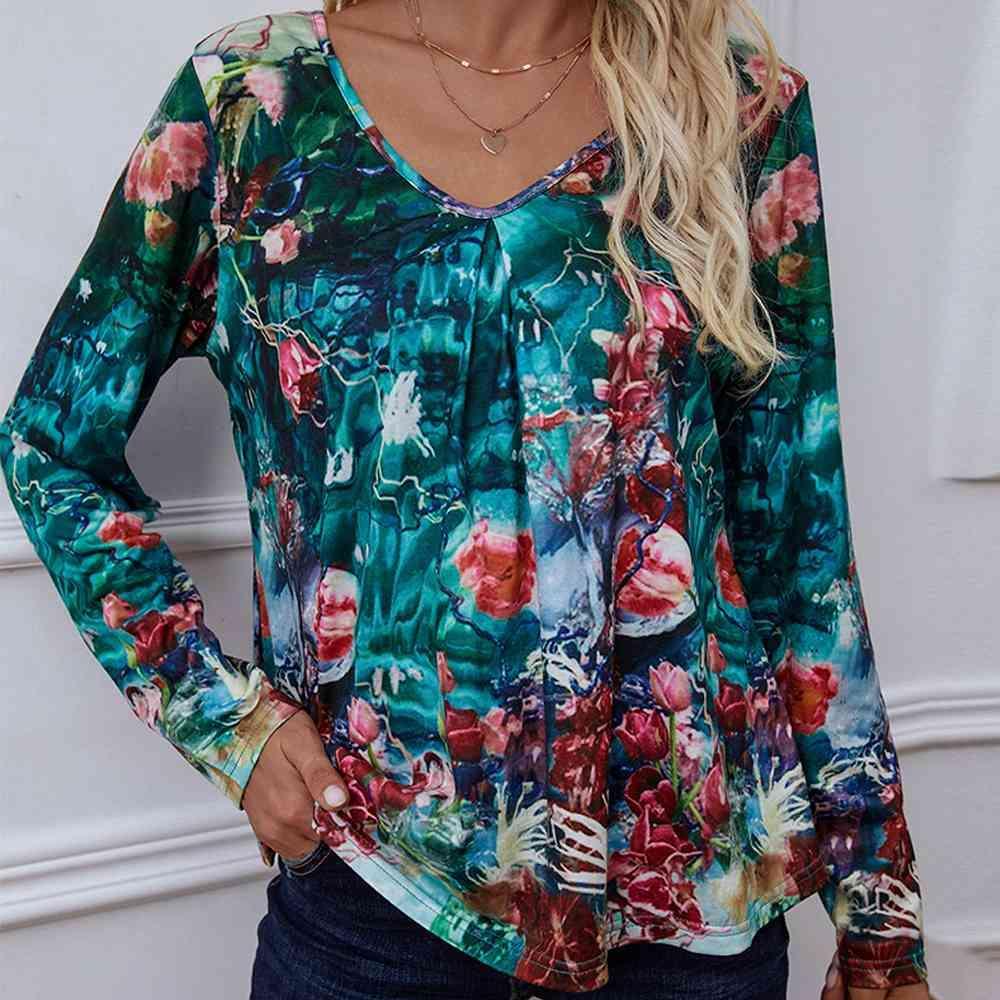 a woman wearing a floral blouse and jeans