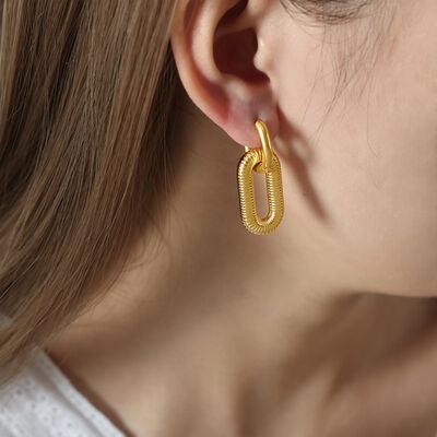 a close up of a person wearing a pair of earrings