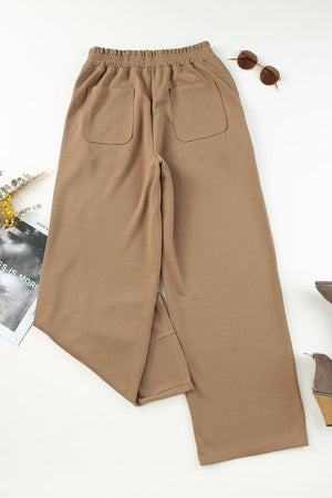 a pair of brown pants sitting on top of a white table