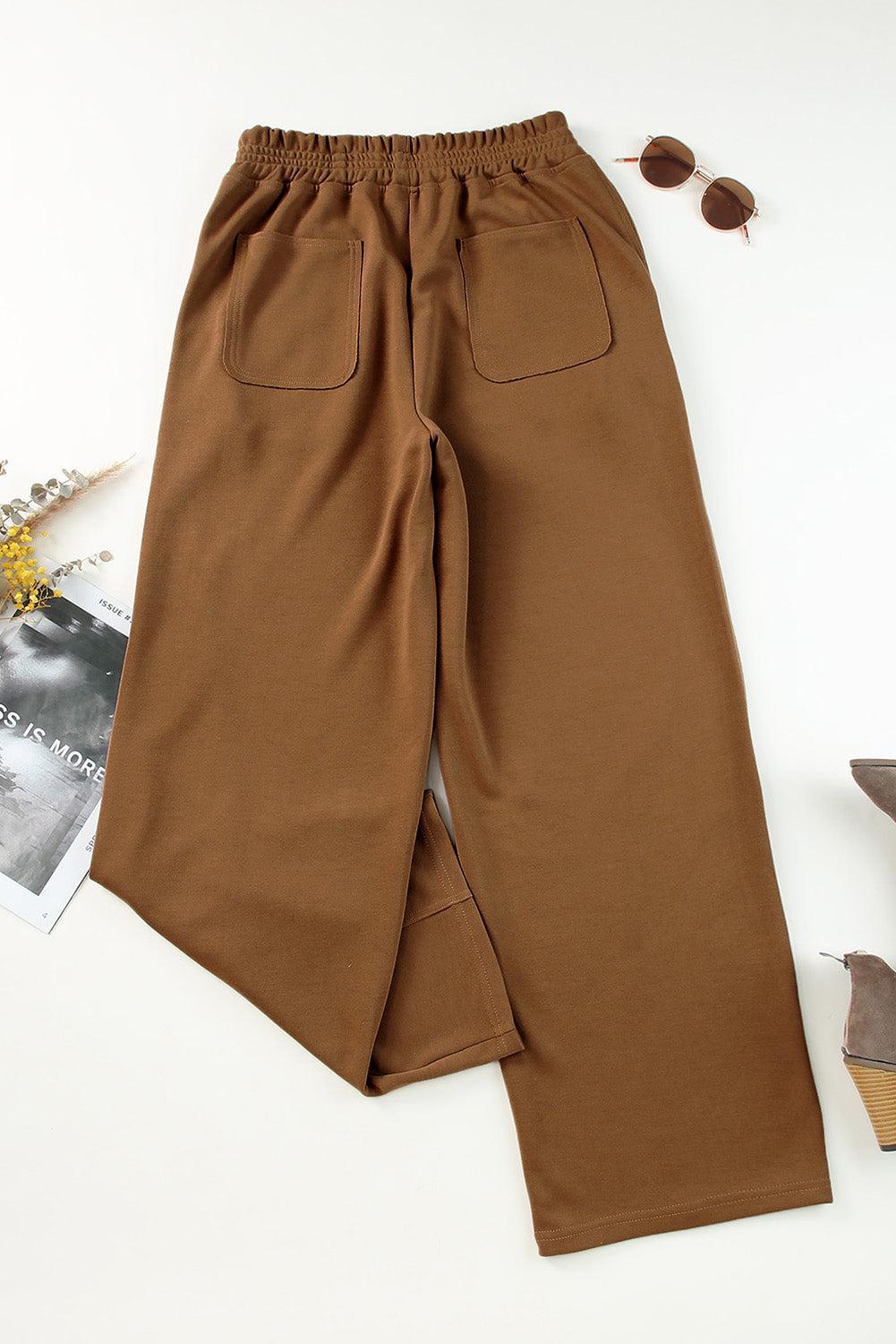 a pair of brown pants sitting on top of a white table