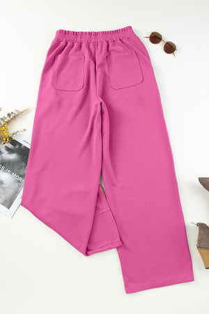 a pair of pink pants next to a pair of sunglasses