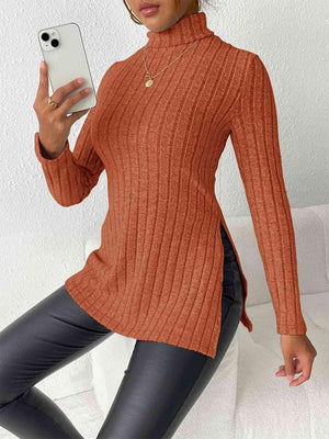 a woman in a turtle neck sweater holding a cell phone