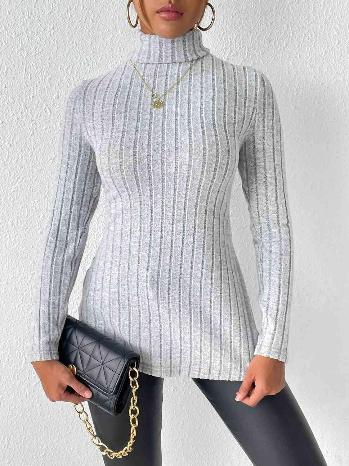 a woman wearing a turtle neck sweater and leggings