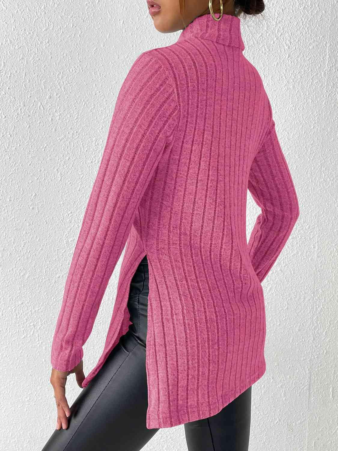 a woman wearing a pink sweater and black leggings