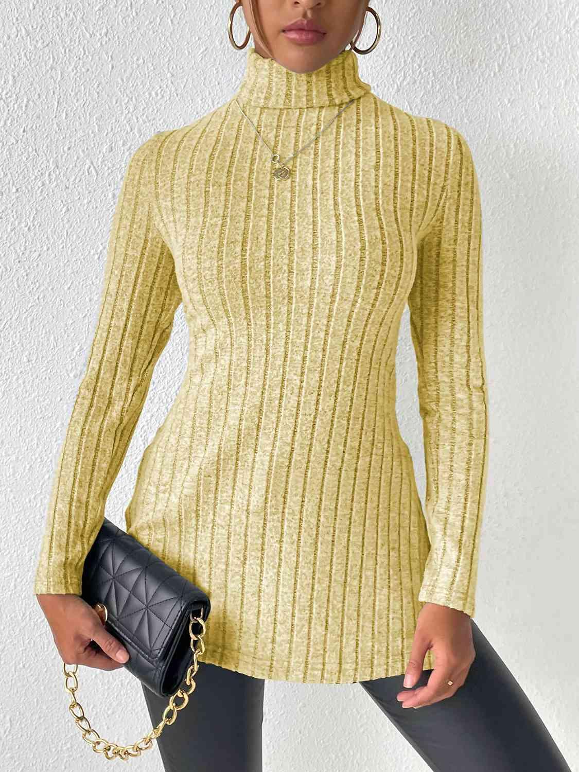 a woman in a yellow sweater holding a black purse