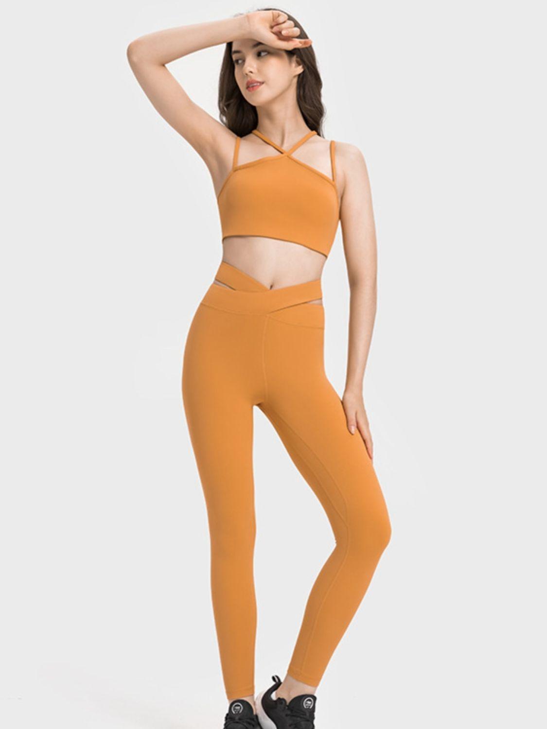 a woman in an orange sports bra top and leggings