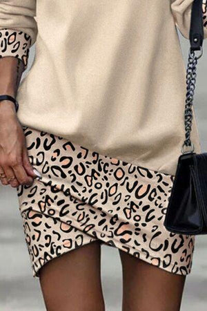 a woman in a leopard print skirt holding a black purse