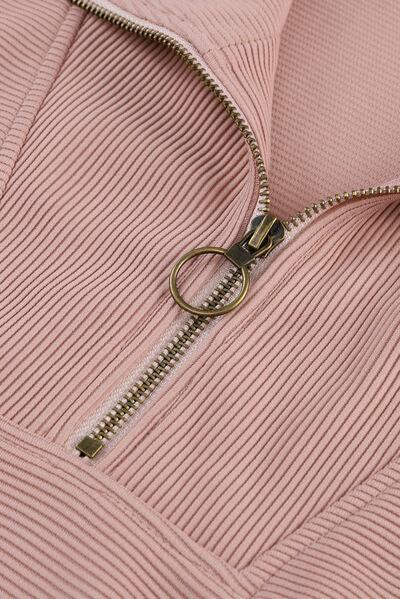 a pink jacket with a zipper is shown