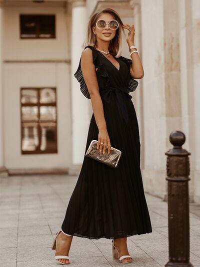 a woman in a black dress is posing for a picture