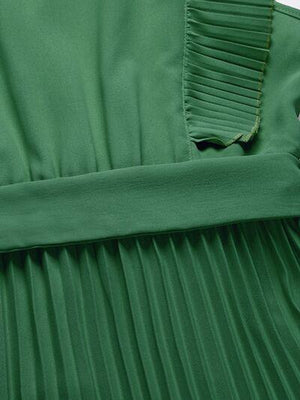 a close up of a green pleated dress