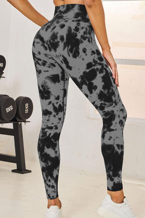 a woman wearing a black and white tie dye leggings