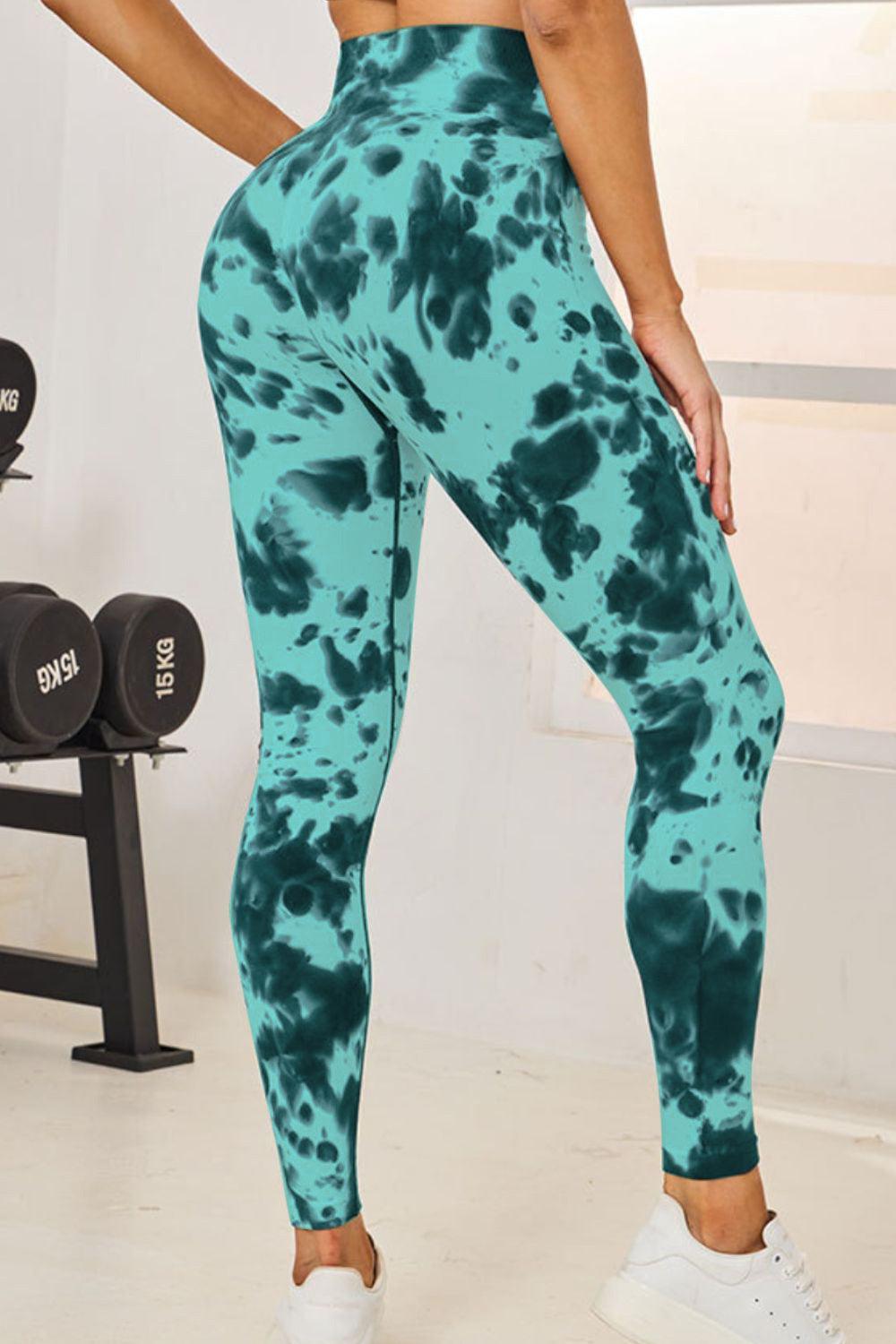 a woman in a green and black tie dye leggings